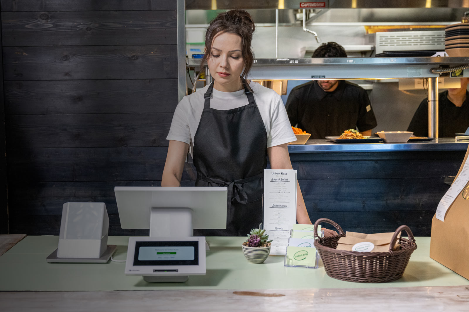 Employee behind the counter at Clover Station Duo